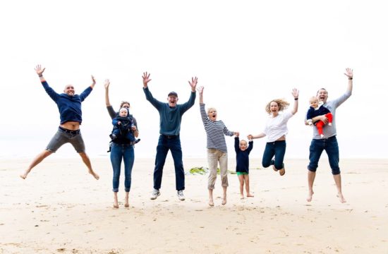family jumping at Watergate beach Cornwall